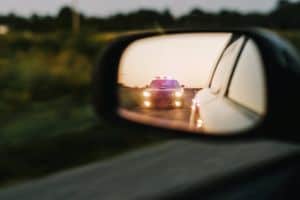 Stylish Side Mirror Car Chase Shot: Highway Traffic Patrol Vehicle Pull over Suspect.